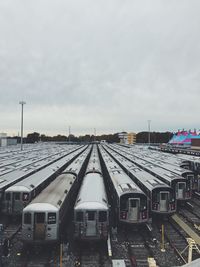 Train at railroad station against sky