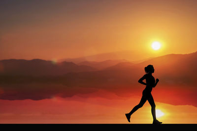 Silhouette woman running against sky during sunset