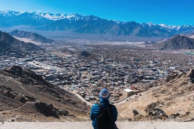 Woman photographing with mountains in background