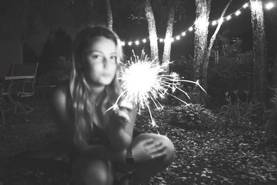 Young woman looking away at night