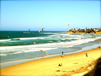 Scenic view of beach against clear blue sky