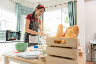 Portrait of young woman sitting on table