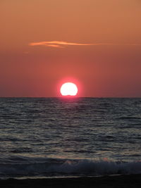 Scenic view of sea against orange sky