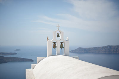 Built structure by sea against sky