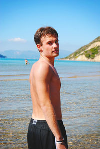 Rear view of man standing on beach