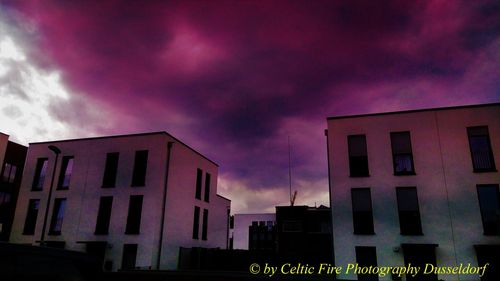 Low angle view of building against dramatic sky