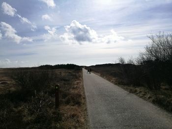 Empty road along countryside landscape