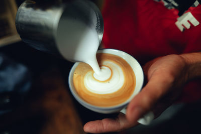 Midsection of woman holding coffee