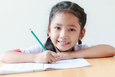 Close-up portrait of happy boy on table