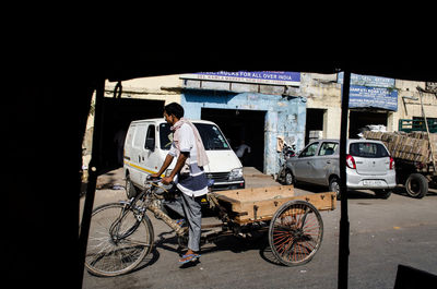 Man riding bicycle on street in city