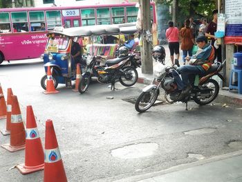 People riding bicycle on road in city