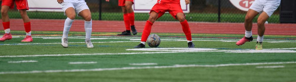 People playing soccer on field