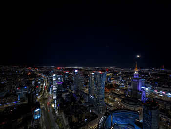 High angle view of illuminated buildings in city at night
