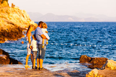 Full length of family looking at sea