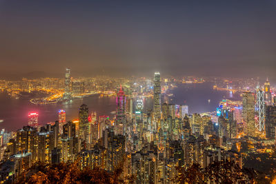 High angle view of illuminated cityscape against sky at night