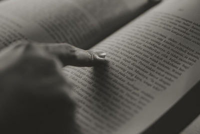 Cropped hand of person writing in book