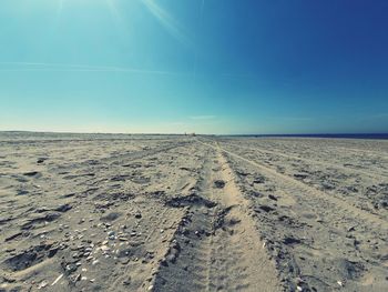 Scenic view of desert against clear blue sky