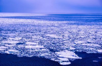 High angle view of sea against sky during winter