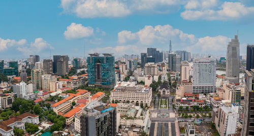 Aerial view of buildings in city against sky