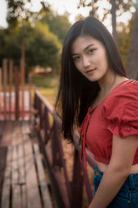 Portrait of beautiful young woman standing outdoors