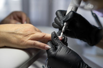 Cropped hand of doctor examining patient in hospital