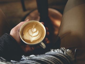 Cropped image of man having coffee at cafe