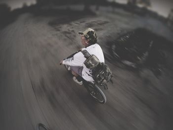 High angle view of mature man riding bicycle on road