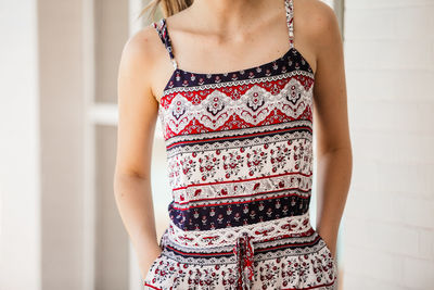 Midsection of woman standing against wall