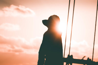 Silhouette man standing against sky during sunset