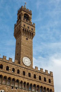 Clock tower of the palazzo vecchio built at the piazza della signoria in florence