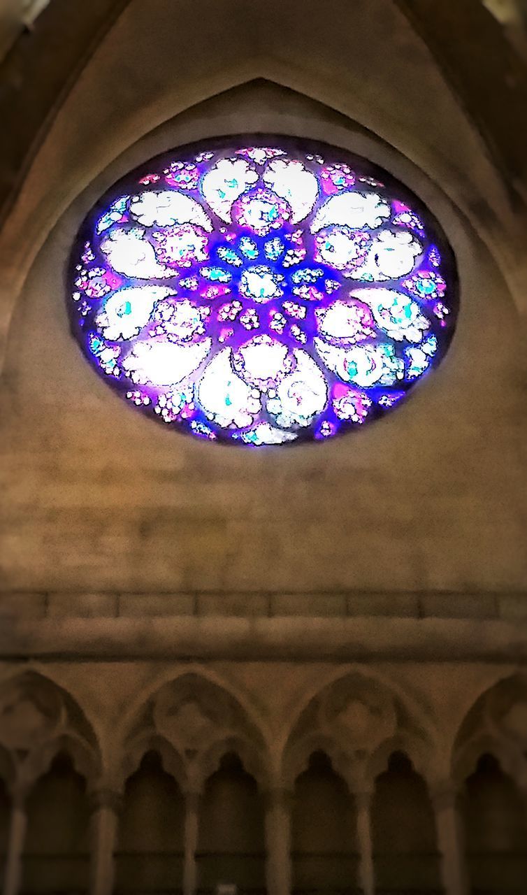 LOW ANGLE VIEW OF ILLUMINATED CHANDELIER HANGING ON BUILDING