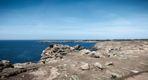 Rocks on beach against sky