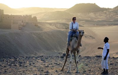 Man riding horse on sand