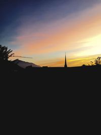 Silhouette of built structure at sunset