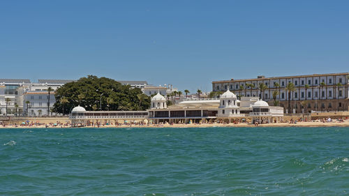 View of buildings in city against clear sky