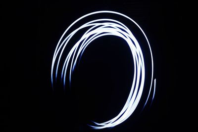 Close-up of light trails over black background