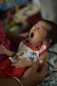 Cute baby girl lying on bed