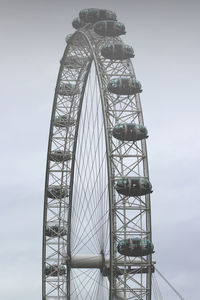 Low angle view of ferris wheel against sky