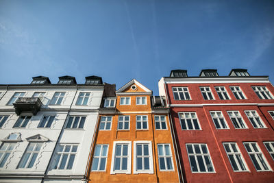 Low angle view of residential buildings against blue sky