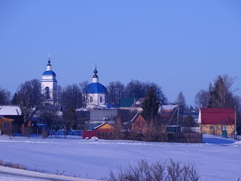 Buildings against clear sky during winter