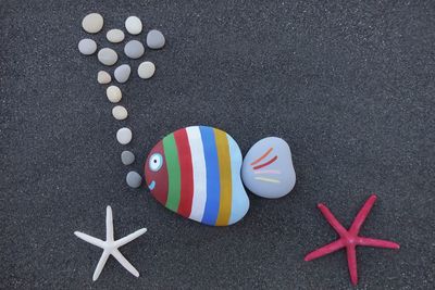 Directly above shot of colorful decoration on sand