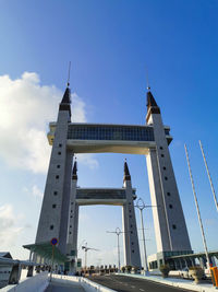 Low angle view of bridge against cloudy sky