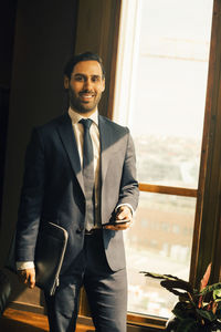 Portrait of smiling lawyer standing in office