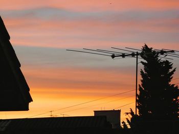 Low angle view of silhouette city against sky during sunset