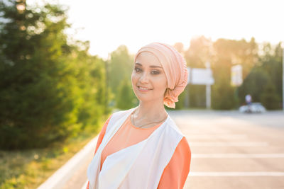 Portrait of a smiling young woman standing outdoors