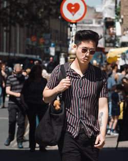 Young man wearing sunglasses standing in city