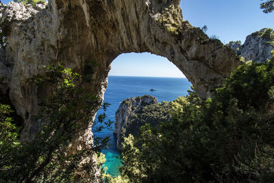 Yacht beneath the arco naturale in capri