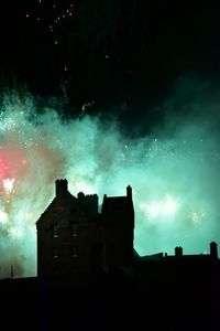 Low angle view of illuminated building against sky