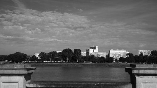 Buildings in city against cloudy sky