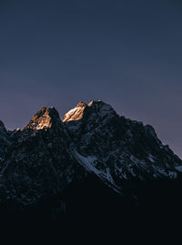 Scenic view of snowcapped mountains against clear sky